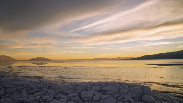 Timelapse of sunset looking over ice on frozen lake
