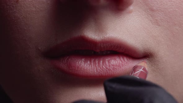 Makeup Artist Applying Lip Pencil on Model Lips