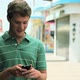 Teenage boy using cellphone and laughing - VideoHive Item for Sale