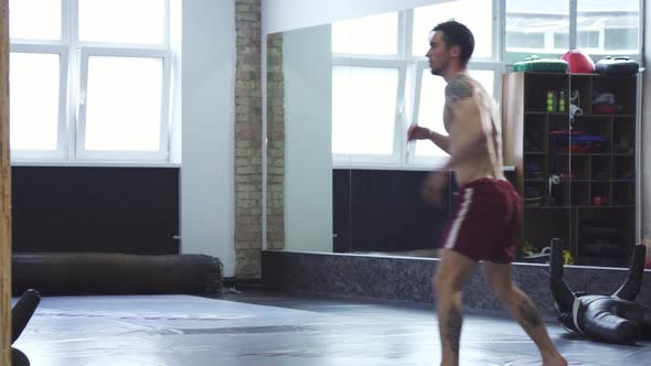 Professional Mma Fighter Training at the Gym, Doing Spinning High Kicks