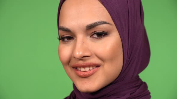 A Young Beautiful Muslim Woman Smiles at the Camera  Face Closeup  Green Screen Background