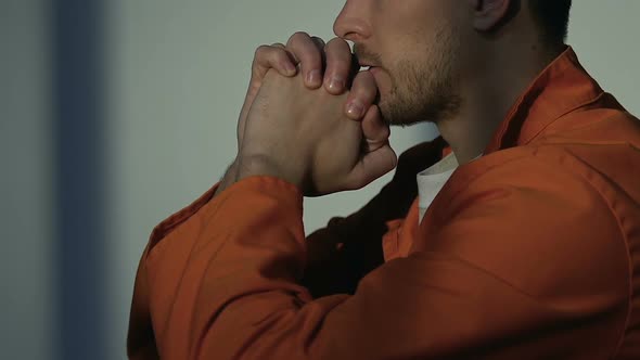 Religious Caucasian Prisoner Praying God in Cell, Asking for Forgiveness, Faith