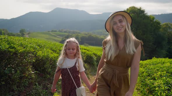 Little Girl Walking Mum in Green Highlands