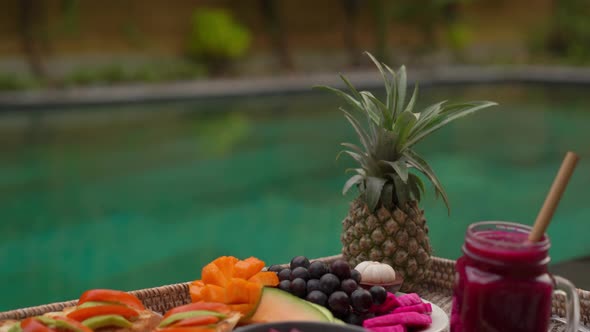 Closeup Shot of a Personal Breakfast on a Floating Table in a Private Swimming Pool. Tropical Beach