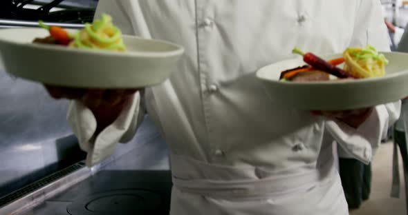 Happy chef presenting his food plates