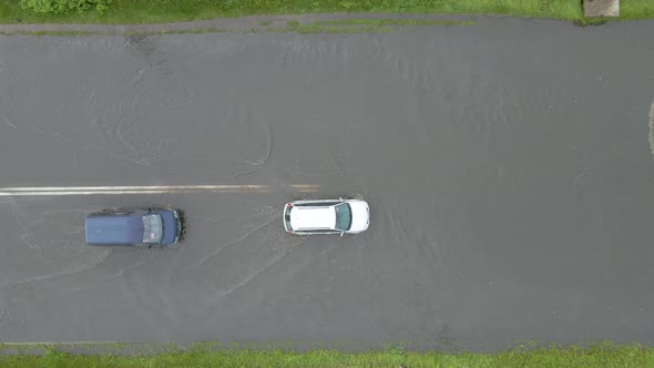 Aerial View of City Traffic with Cars Driving on Flooded Street After Heavy Rain