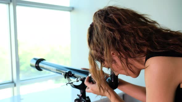 Woman Looking Though the Telescope alt