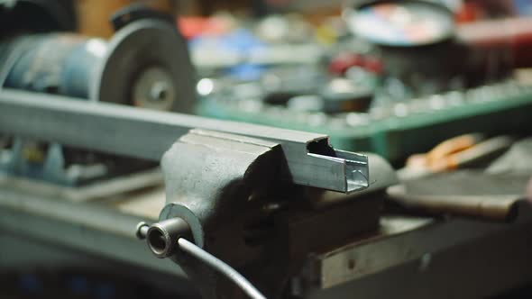 Industry Worker Sanding Metal with Metal File