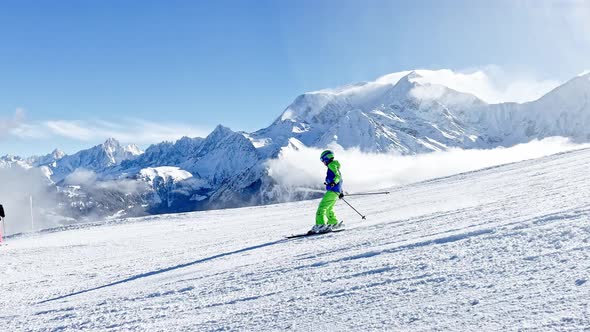 Child Ride Fast on Ski Slope Downhill Over Alps Mont Blanc Tops