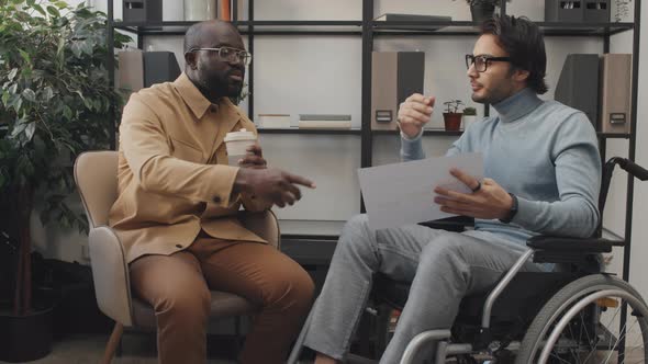 Two Diverse Men Talking in Office