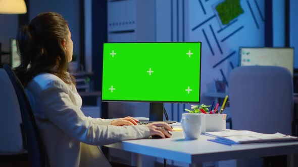 Businesswoman Looking at Green Screen Monitor of Computer