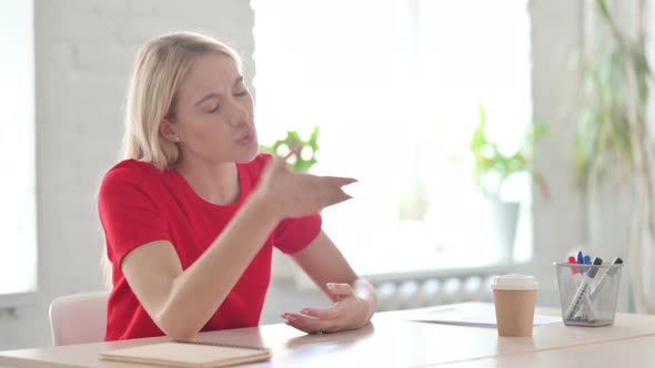 Tense Young Blonde Woman Feeling Frustrated while Sitting in Office