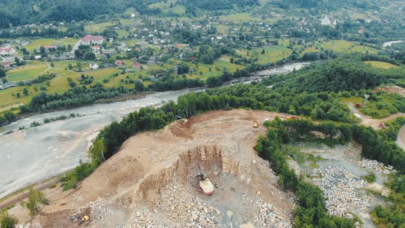 Aerial View Flight Over a Quarry in the Mountains Where Stones and Other Rocks Are Mined. Heavy