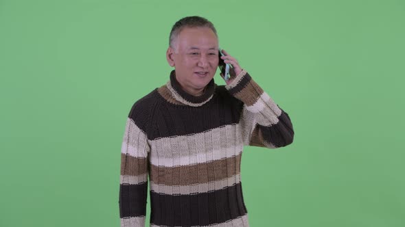 Happy Mature Japanese Man Talking on the Phone