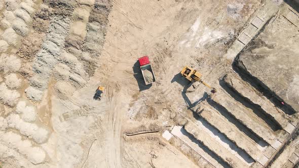 Bulldozer Works on Construction Site with Sand Aerial or Top View