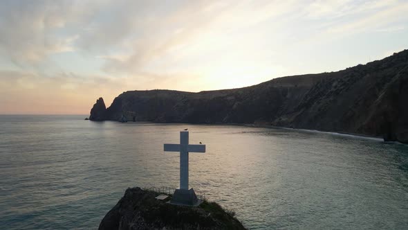 Rock with a Cross Standing on the Sea During Sunset in the Crimea