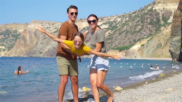 Young Family on White Beach During Summer Vacation