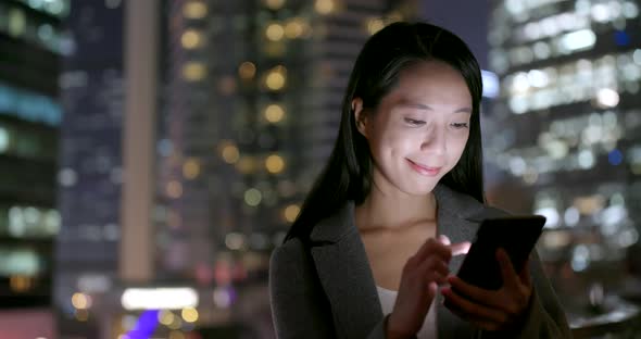 Business woman use of cellphone at night