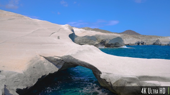 4K White Chalk Cliffs and Natural Arch of Sarakiniko Beach on Milos island, Greece