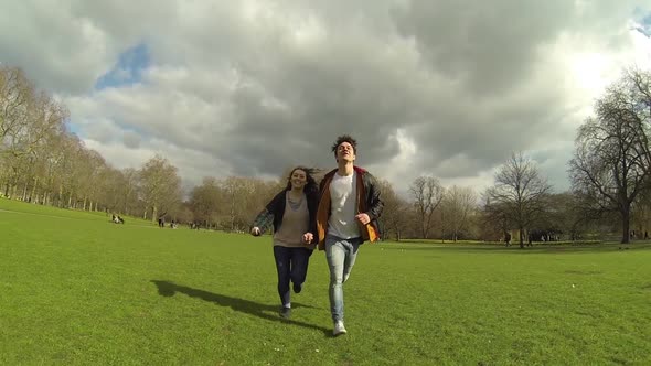 Couple running at park in London