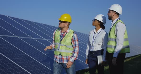 Electrical Workers Walking at a Solar Farm