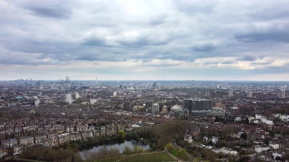 Wide panoramic aerial shot panning left over London cityscape on overcast cloudy day