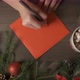 A Woman's Hands Writing a Christmas Card with a Pen Surrounded By Christmas Decorations - VideoHive Item for Sale