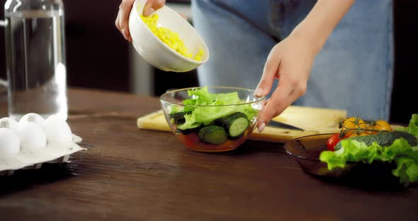 Women's Hands Pour Corn Into a Bowl