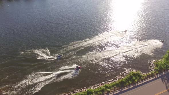 Four Jet-skis racing on a Minnesota lake in the summertime from a drone