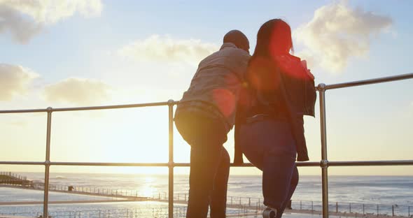 Couple standing near railing on a sunny day 4k