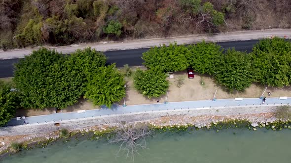 Aerial birdseye view of a pathway and a road along lake Chapala in Jalisco, Mexico