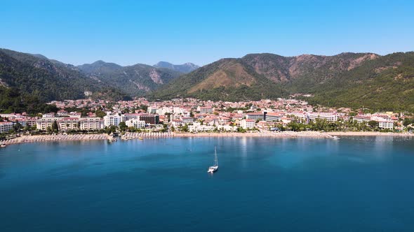 Drone flight over the resort town and hotels against the backdrop of the Mediterranean blue sky of t