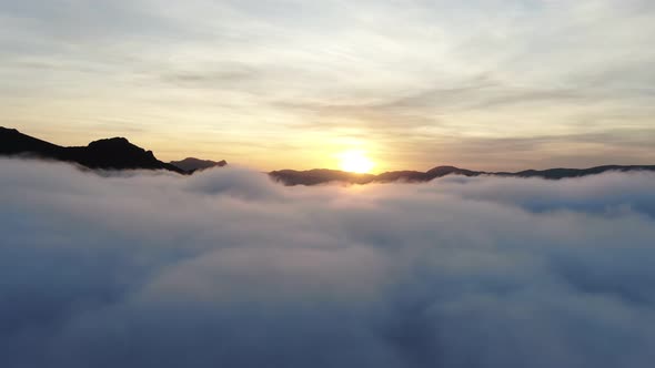 AERIAL CRIMEA NOVEMBER 2019 Drone Shooting a Sunset in the Mountains Between Dense Fog Below and