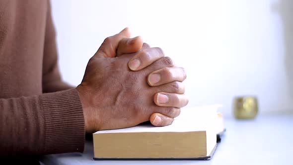 black man holding the Holy Bible after praying in church stock footage