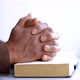 black man holding the Holy Bible after praying in church stock footage - VideoHive Item for Sale