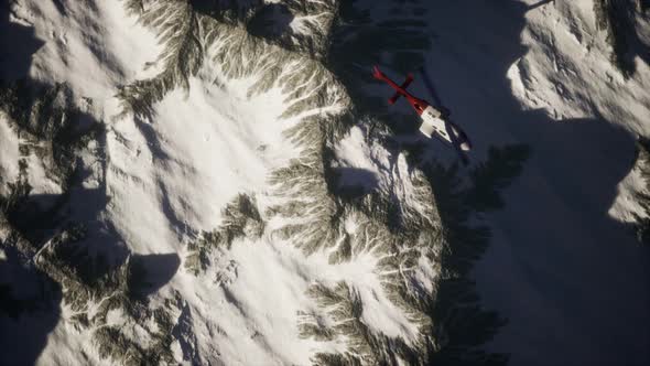 Helicopter Above Mountains in Snow