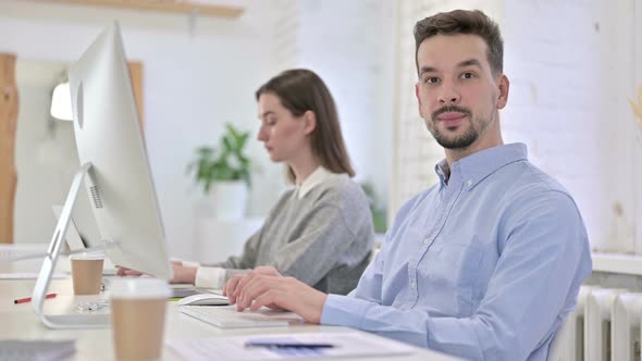 Ambitious Creative Man Showing Thumbs Up in Office