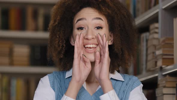 Closeup Young Woman Indoors Speaks Quietly Covering Mouth Hands Telling Confidential Information