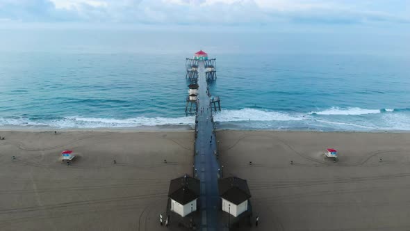 A 4k  ariel view moving towards the Huntington Beach pier in California Surf City USA at sunrise as