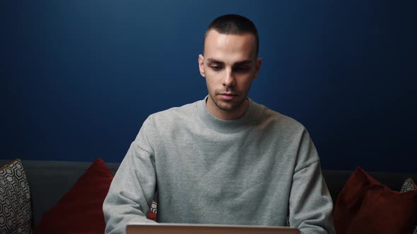 Focused Caucasian Businessman Work and Typing on a Laptop. Young Male Professional Using Laptop