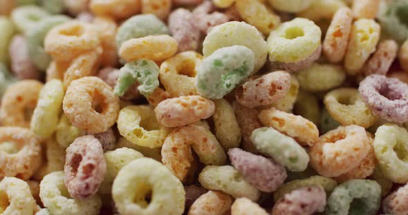 Video of colorful breakfast round cereals on white background