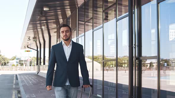 Elegant businessman in airport. Young mail entrepreneur in formalwear.