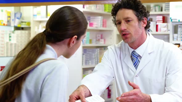 Pharmacist assisting the medicine to customer