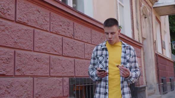 Man in Yellow Eats on the Red Background