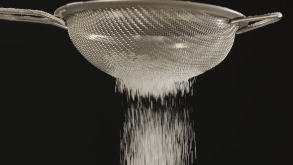 Closeup of Male Hands Sifting Flour Through Small Metal Sieve