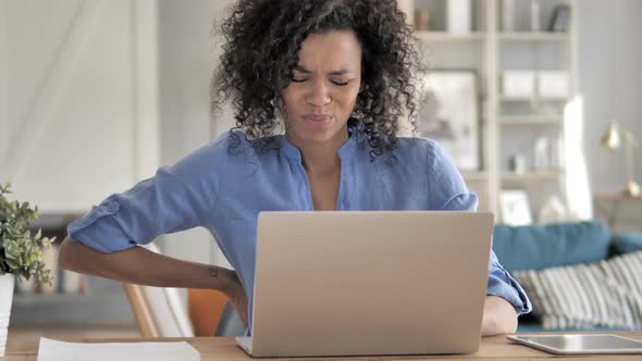 African Woman with Spinal Back Pain at Work