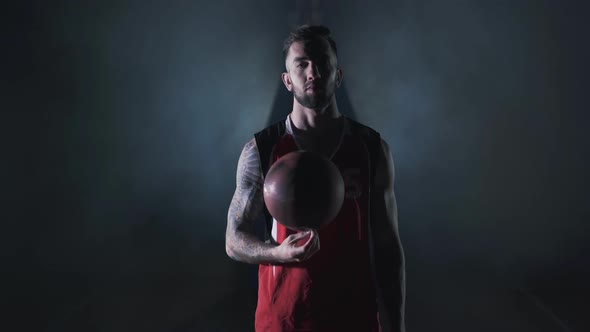 Portrait Young Handsome Bearded Brutal Confident Basketball Player Stand with a Ball in the Clouds