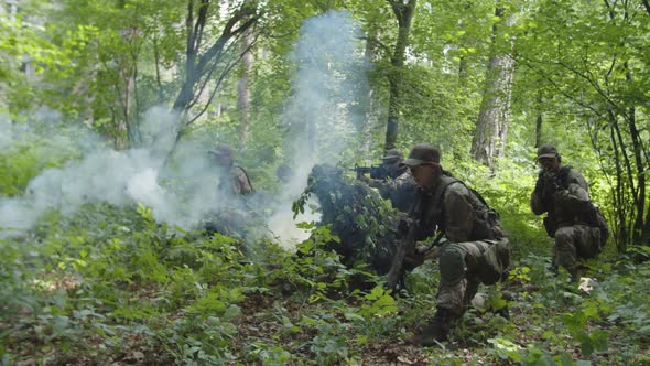 Military Antiterrorist Group Setting Fire to Smoke Grenades Outdoors