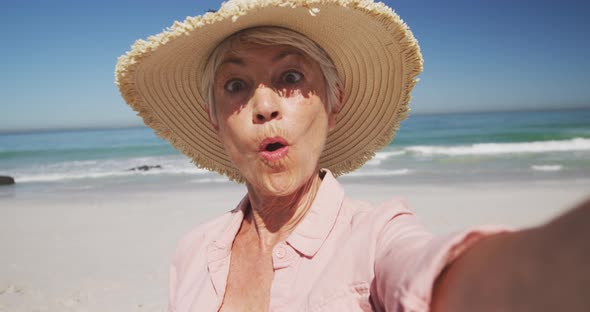 Senior Caucasian woman enjoying time at the beach with sea in the background