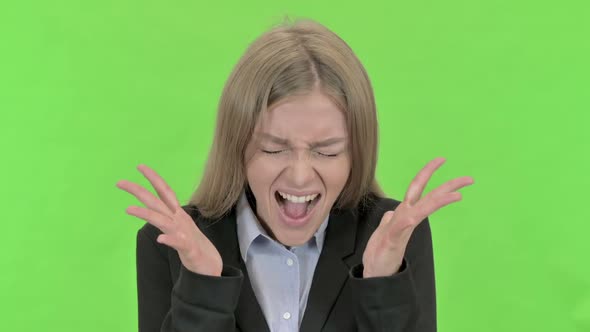 Angry Young Businesswoman Screaming Against Chroma Key